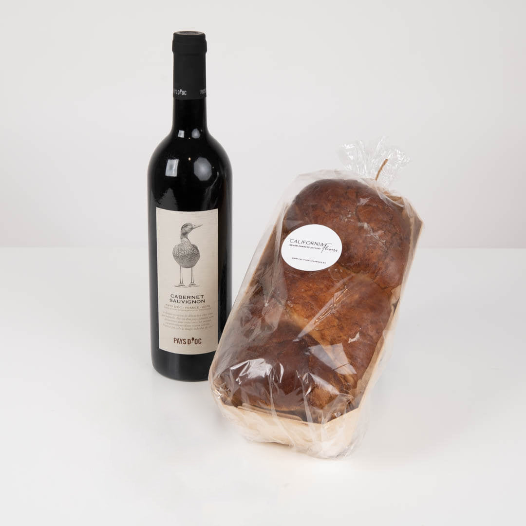 Gift package with red wine and muffin