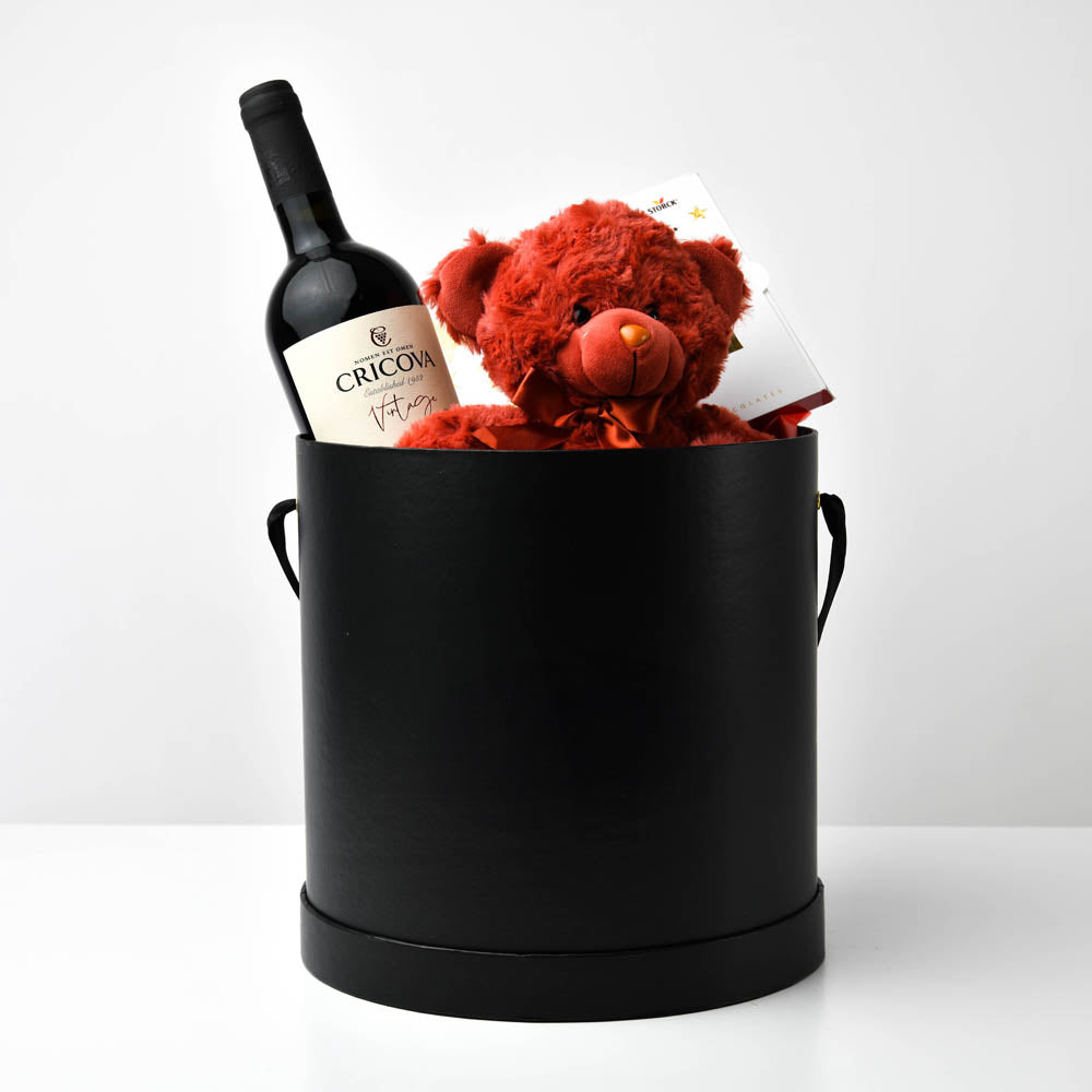 Black gift box with red wine