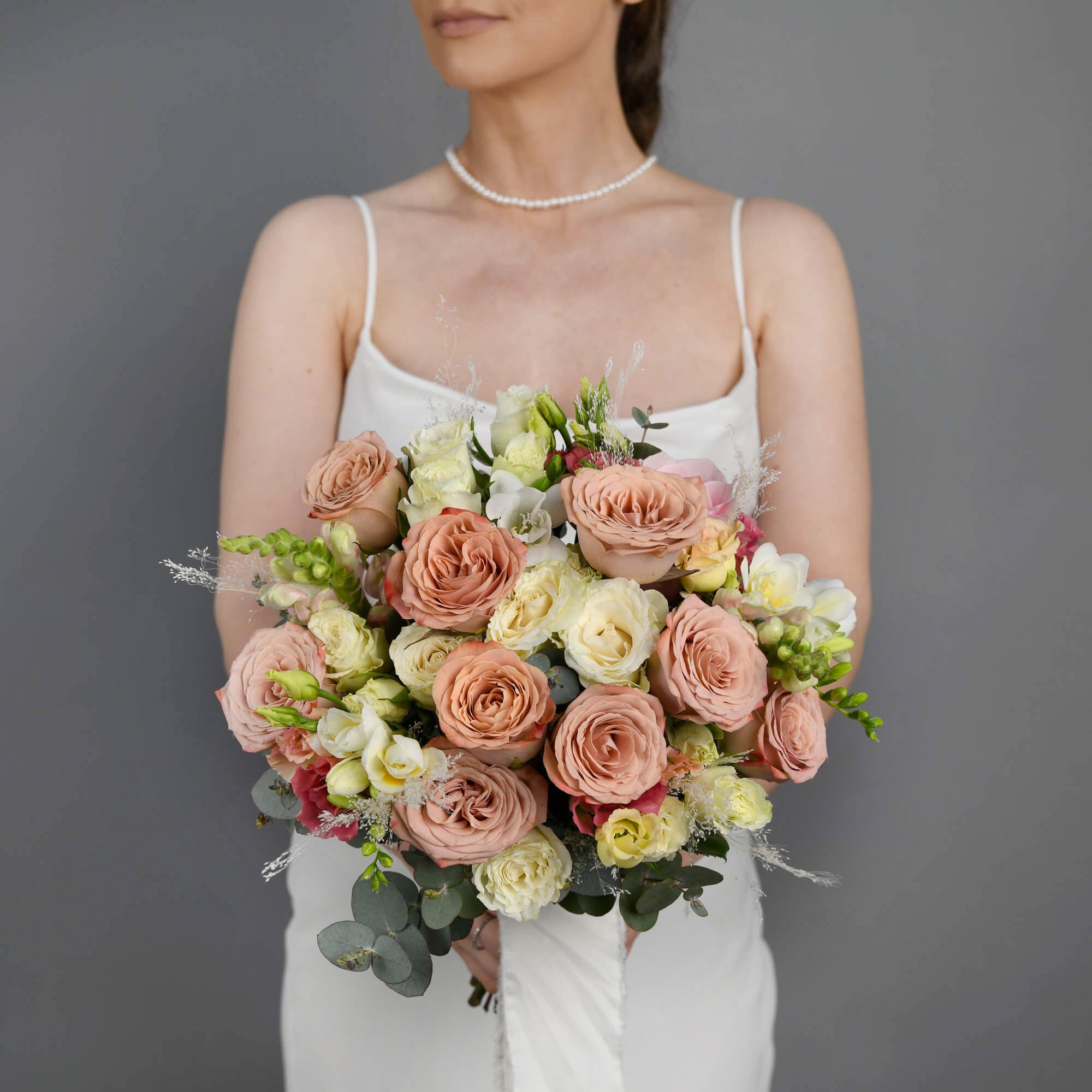 Bridal bouquet with roses and pink antirrhinum