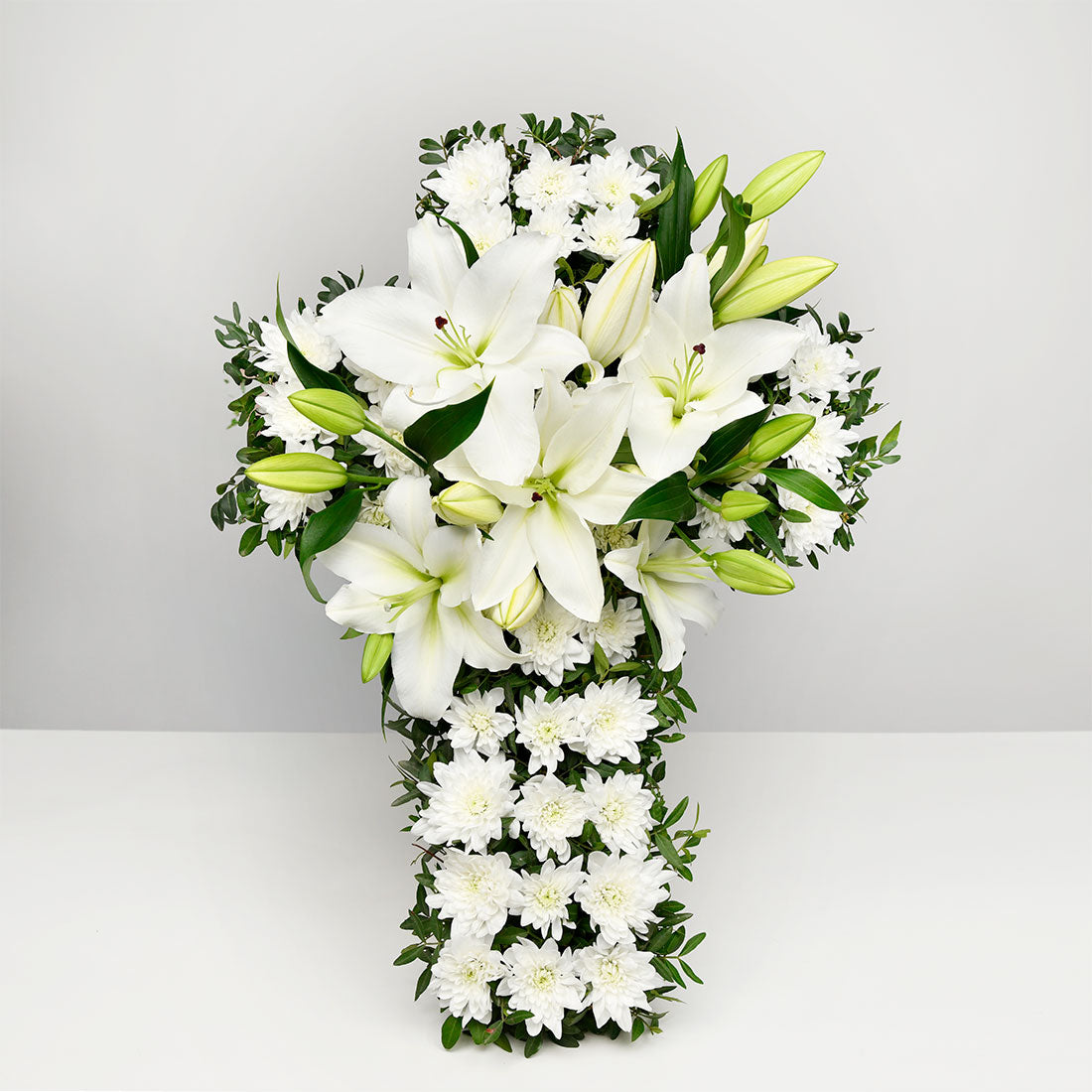 Funeral cross with lilies and chrysanthemums