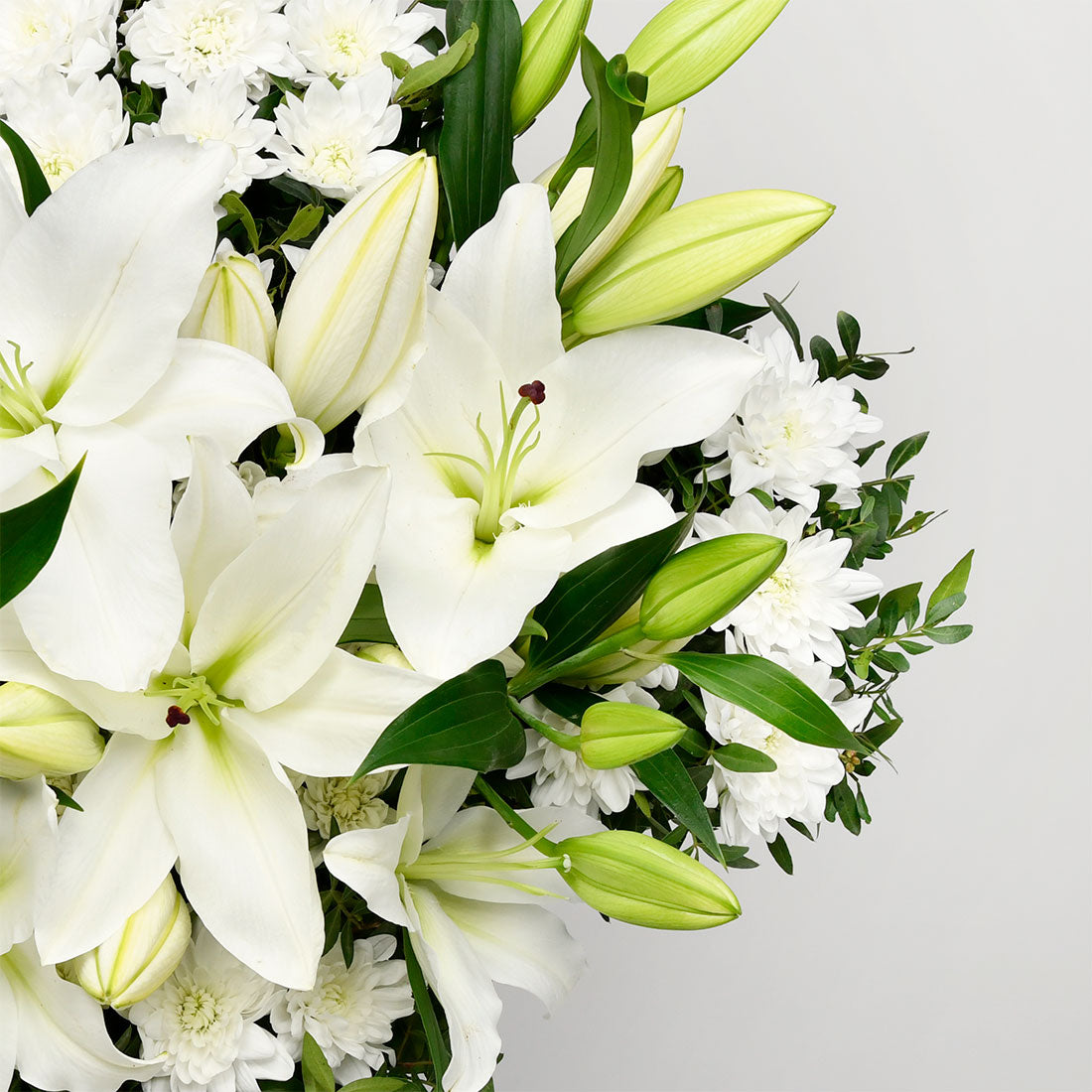 Funeral cross with lilies and chrysanthemums