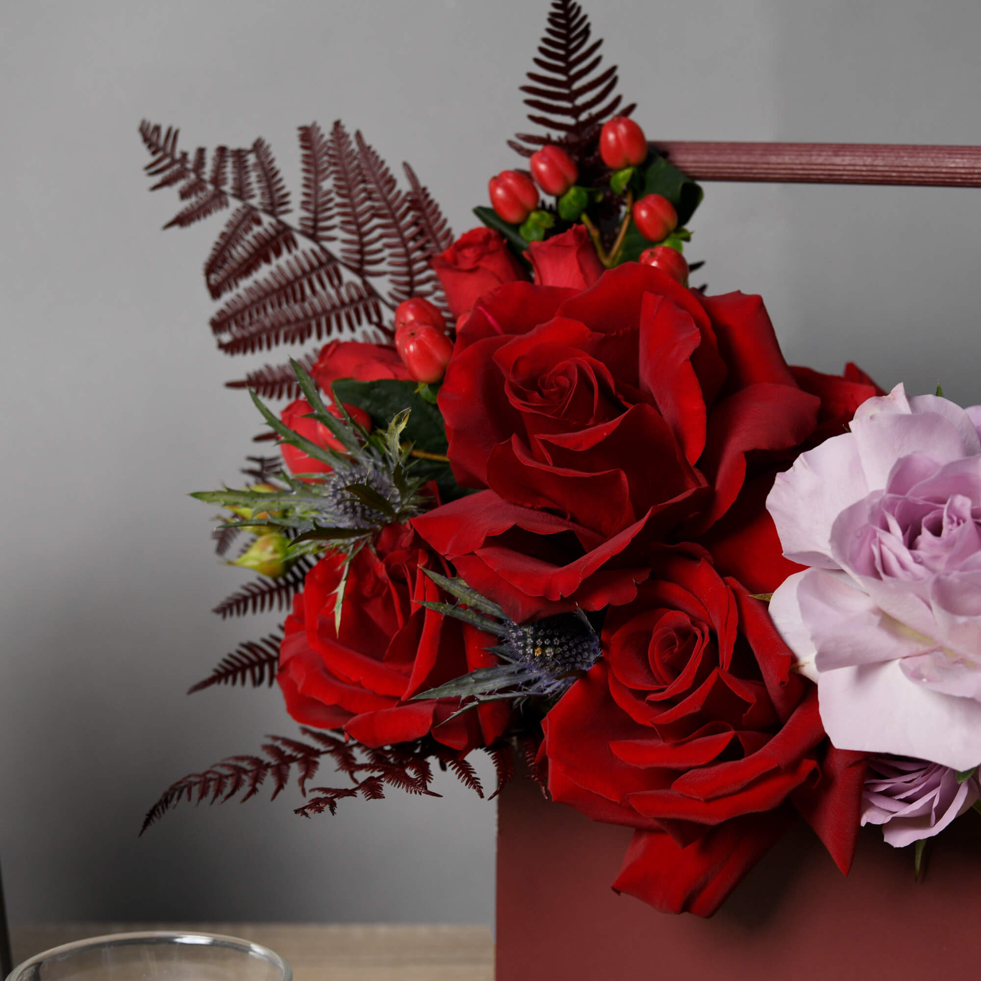 Aranjament in cutie cu trandafiri rosii si lila