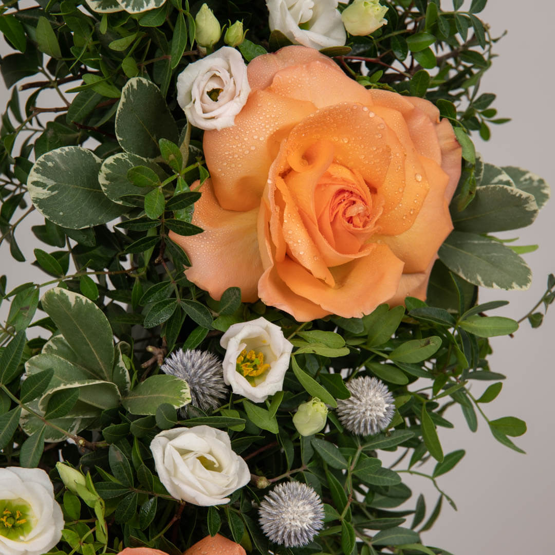 Funeral wreath with salmon roses and lisianthus