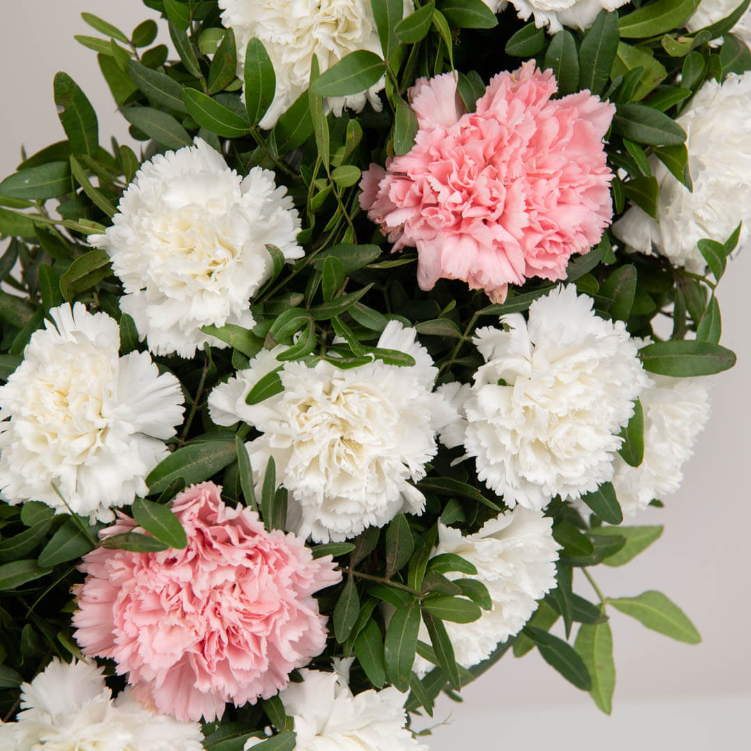 Funeral wreath with lilies, path and pink carnations