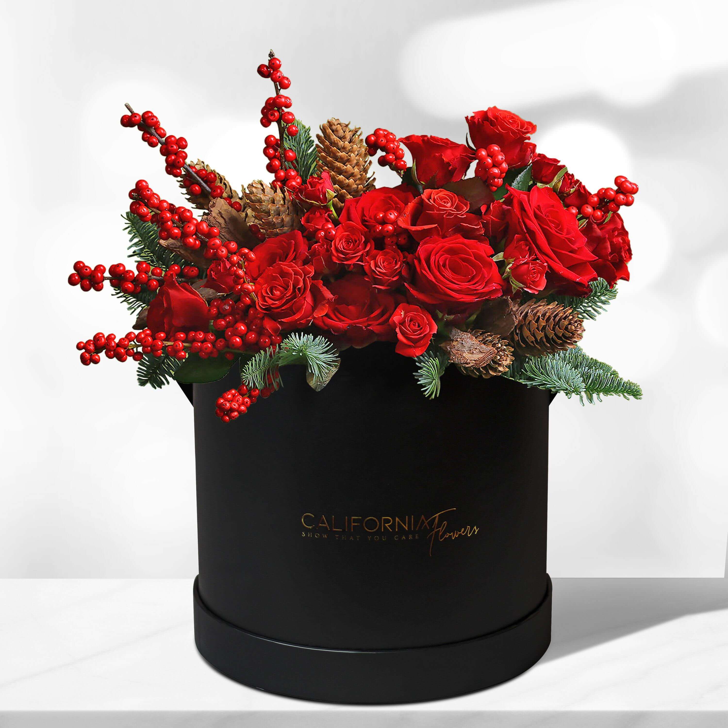 Black box with red roses and fir tree