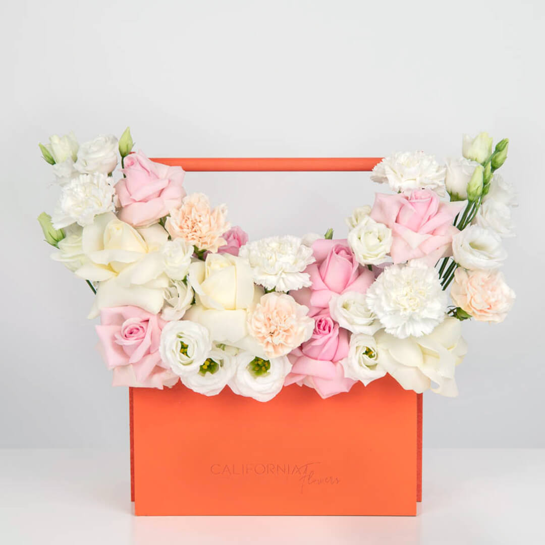 Arrangement in a box with pink roses and lisianthus