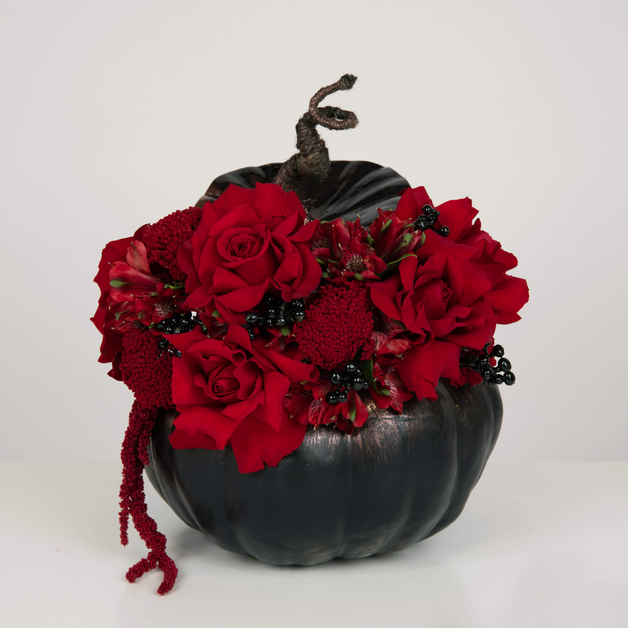 Pumpkin arrangement with roses and alstroemeria