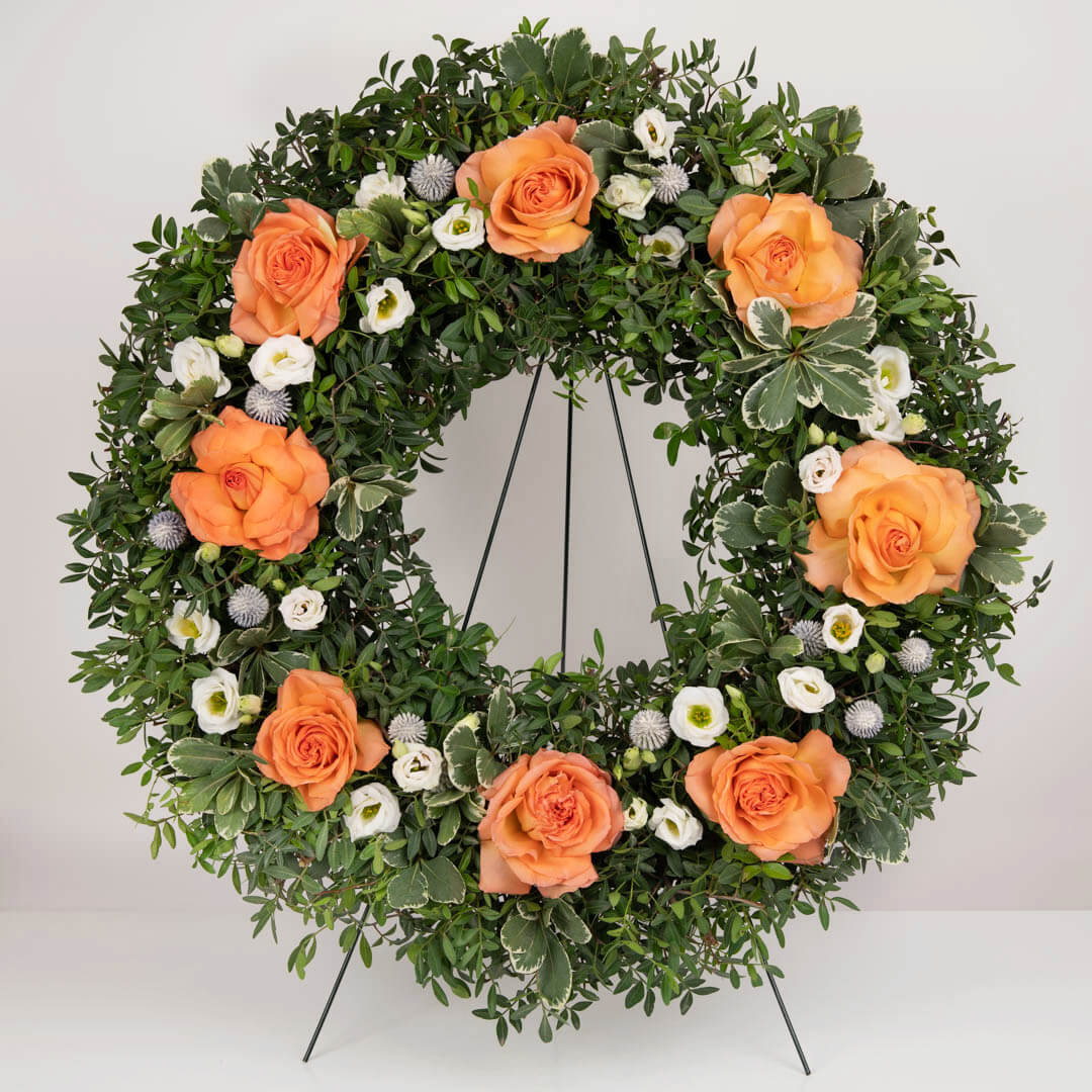 Funeral wreath with salmon roses and lisianthus