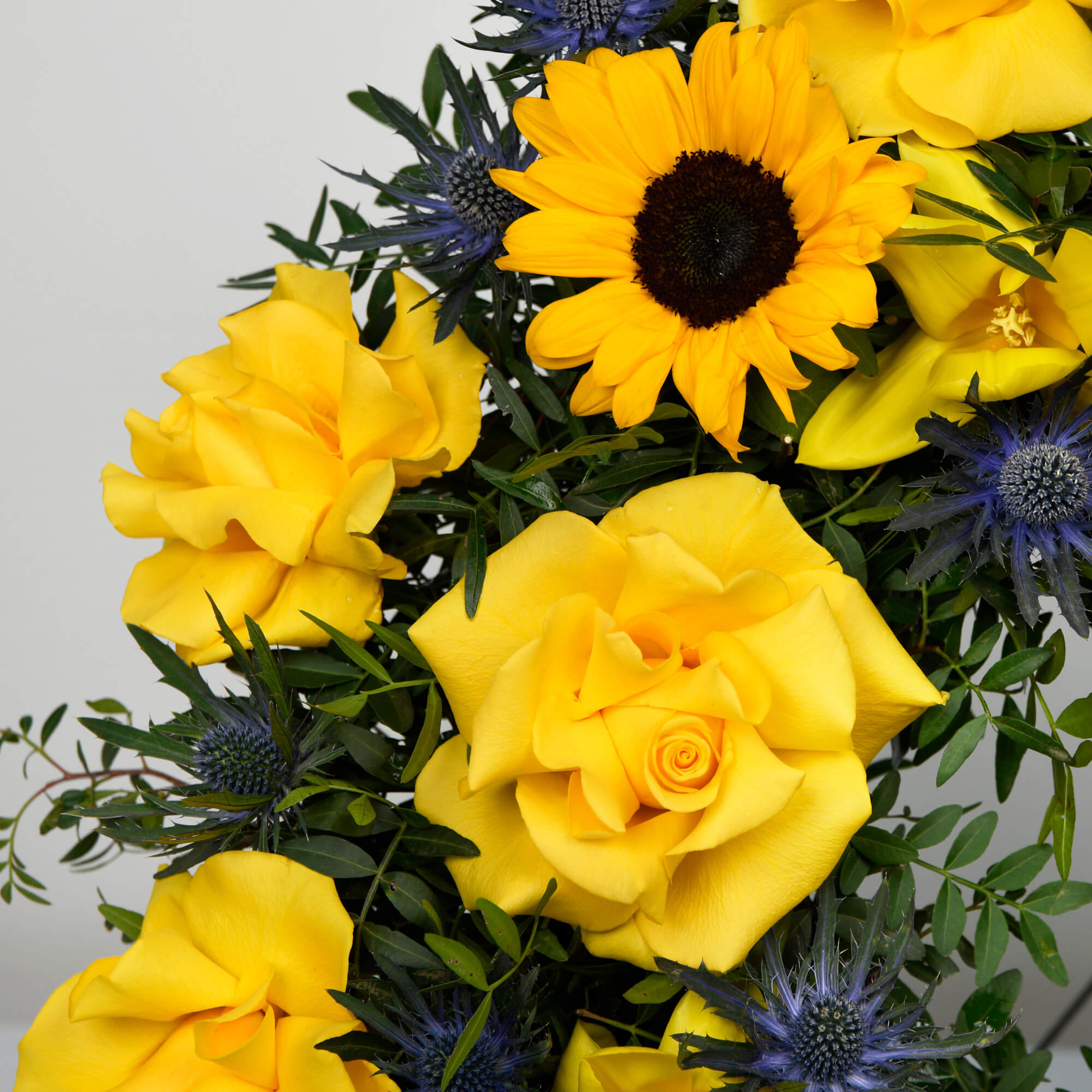 Funeral wreath with roses and sunflowers
