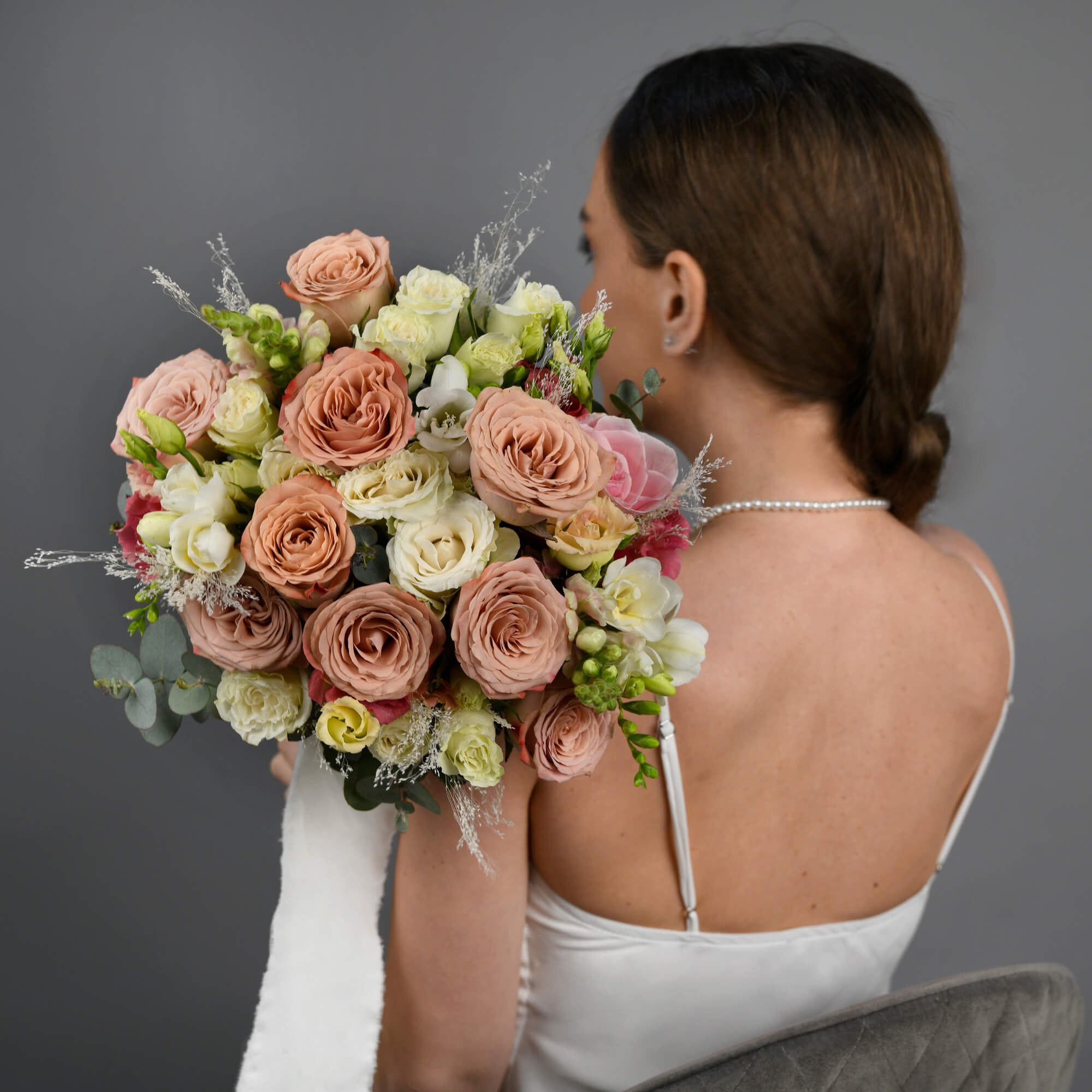 Bridal bouquet with roses and pink antirrhinum