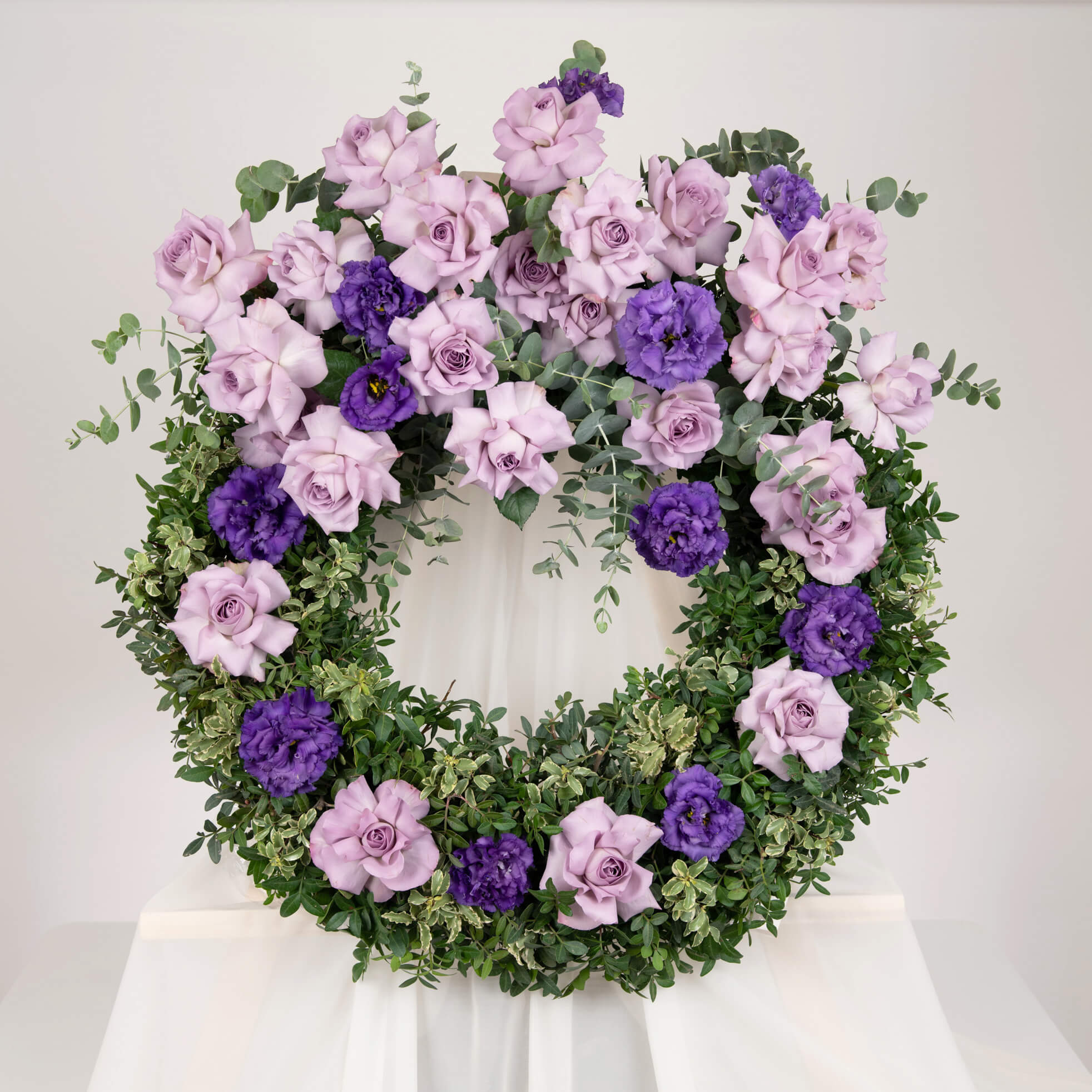 Funeral wreath with purple roses and eucalyptus