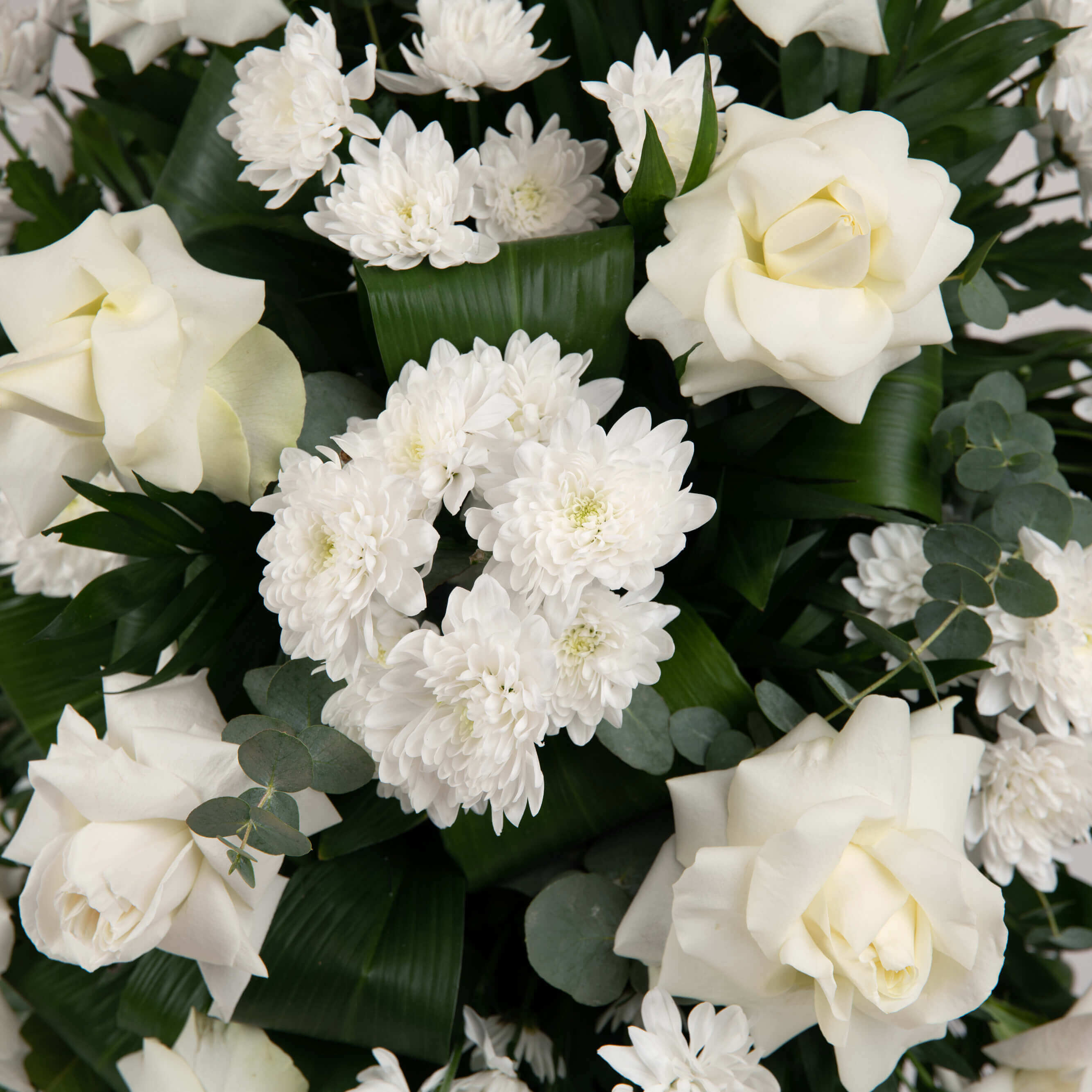 Grass with white roses and chrysanthemums