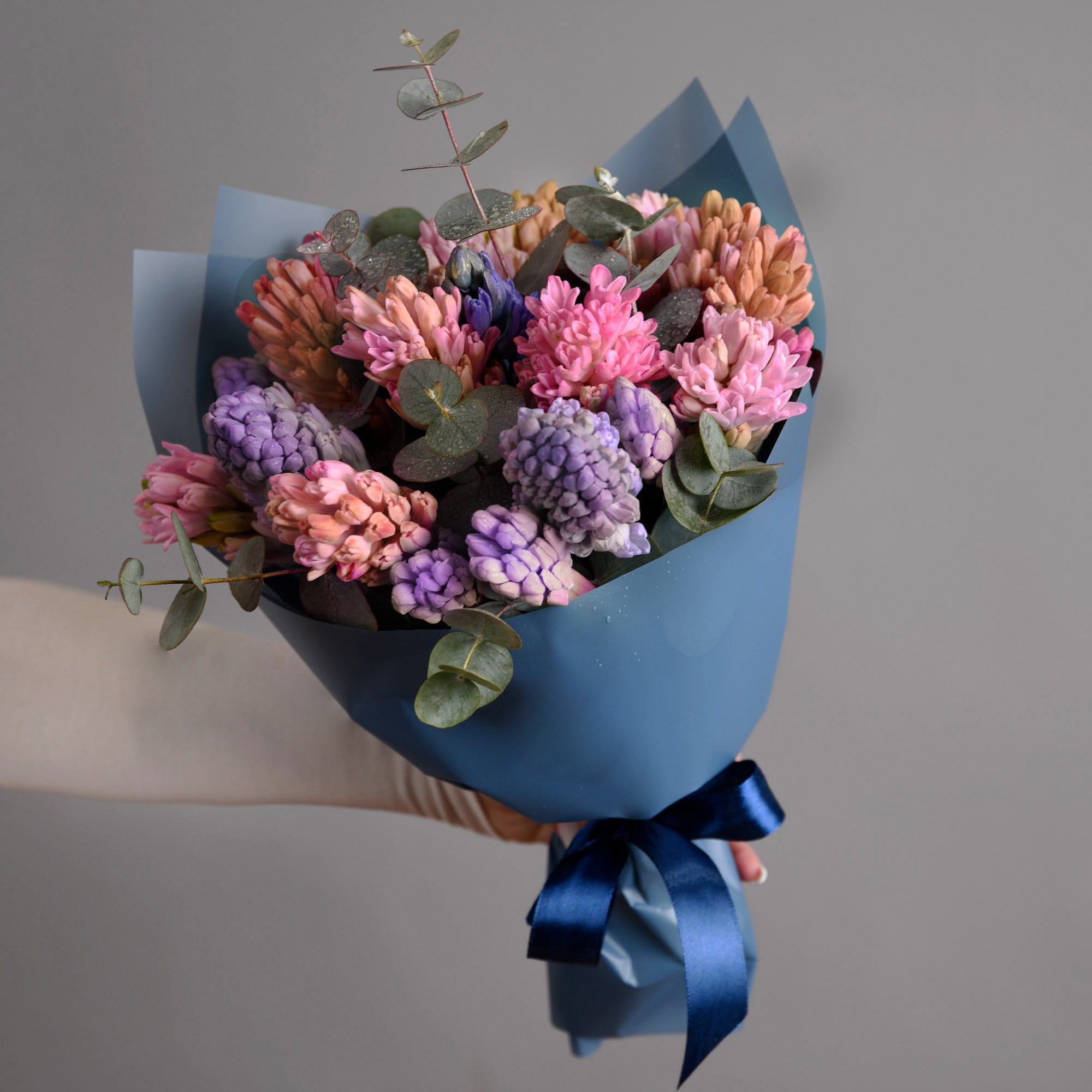 Bouquet with multicolored hyacinths and eucalyptus