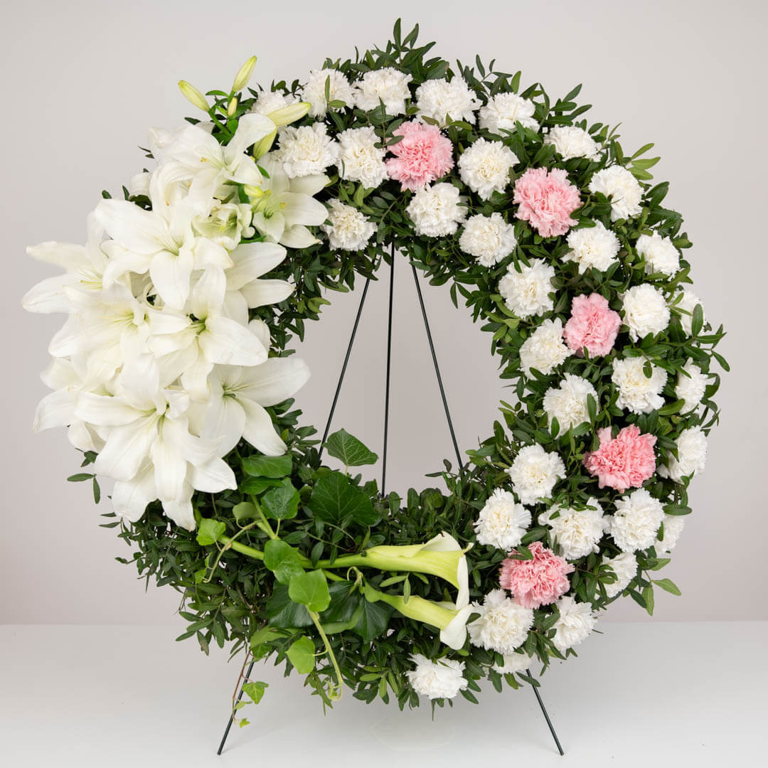Funeral wreath with lilies, path and pink carnations