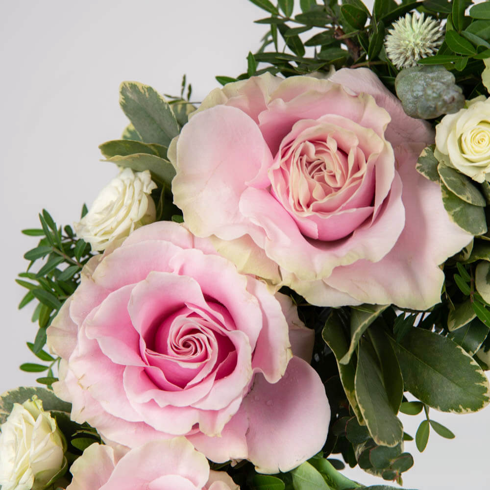 Funeral wreath with pink and broken roses