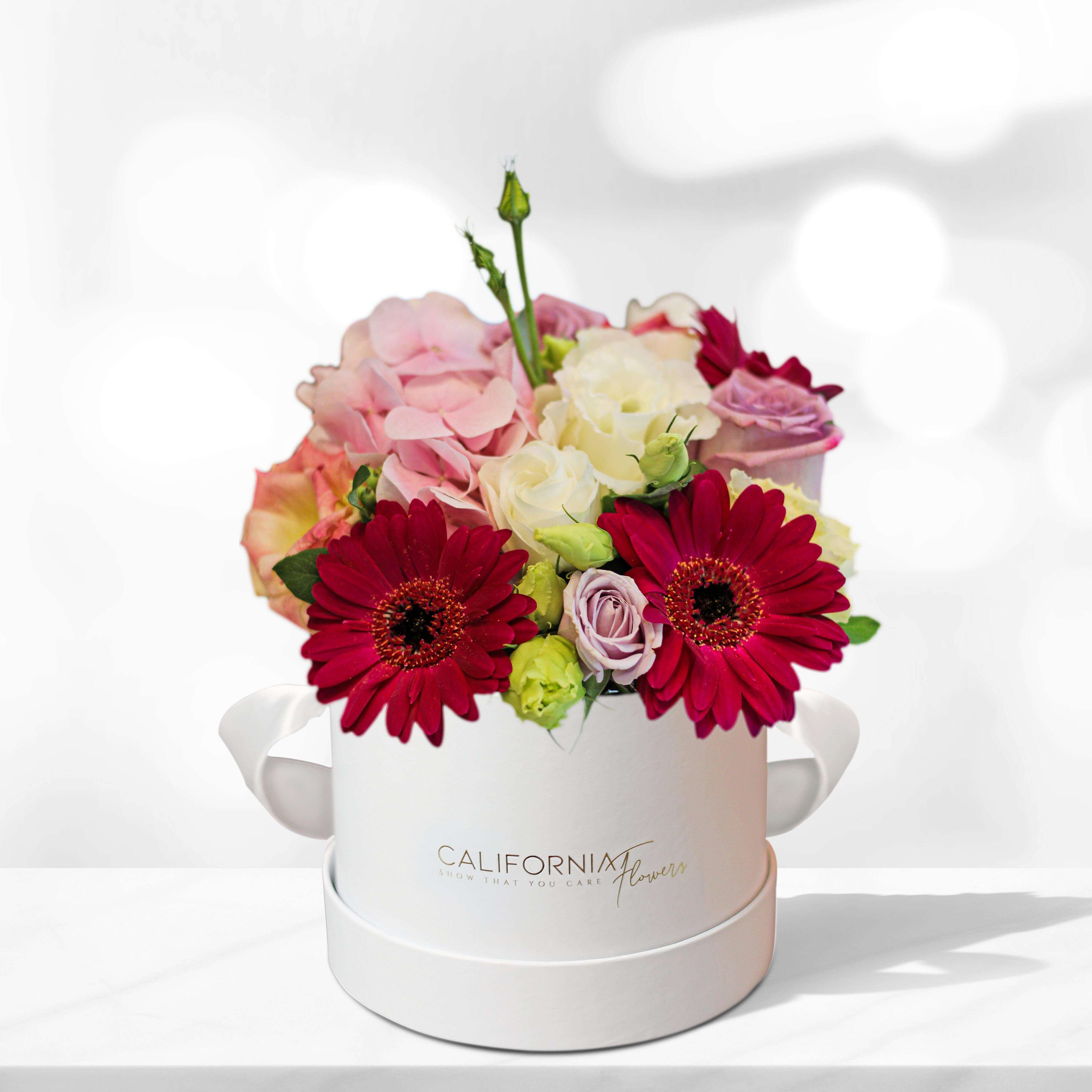 Box with gerbera, ranunculus, roses and lisianthus
